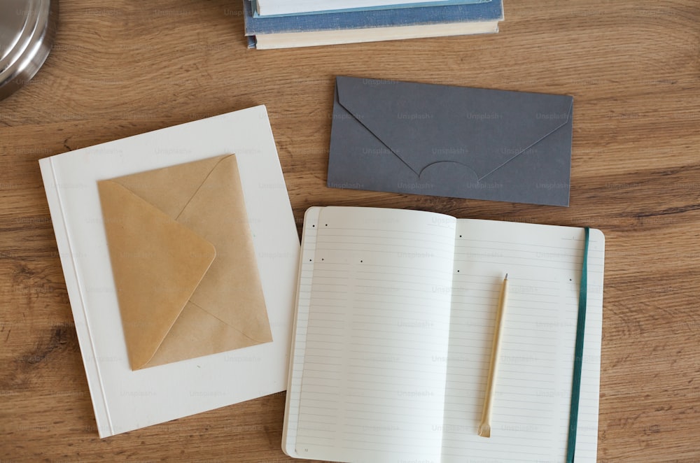 an open notebook and a pen on a wooden table