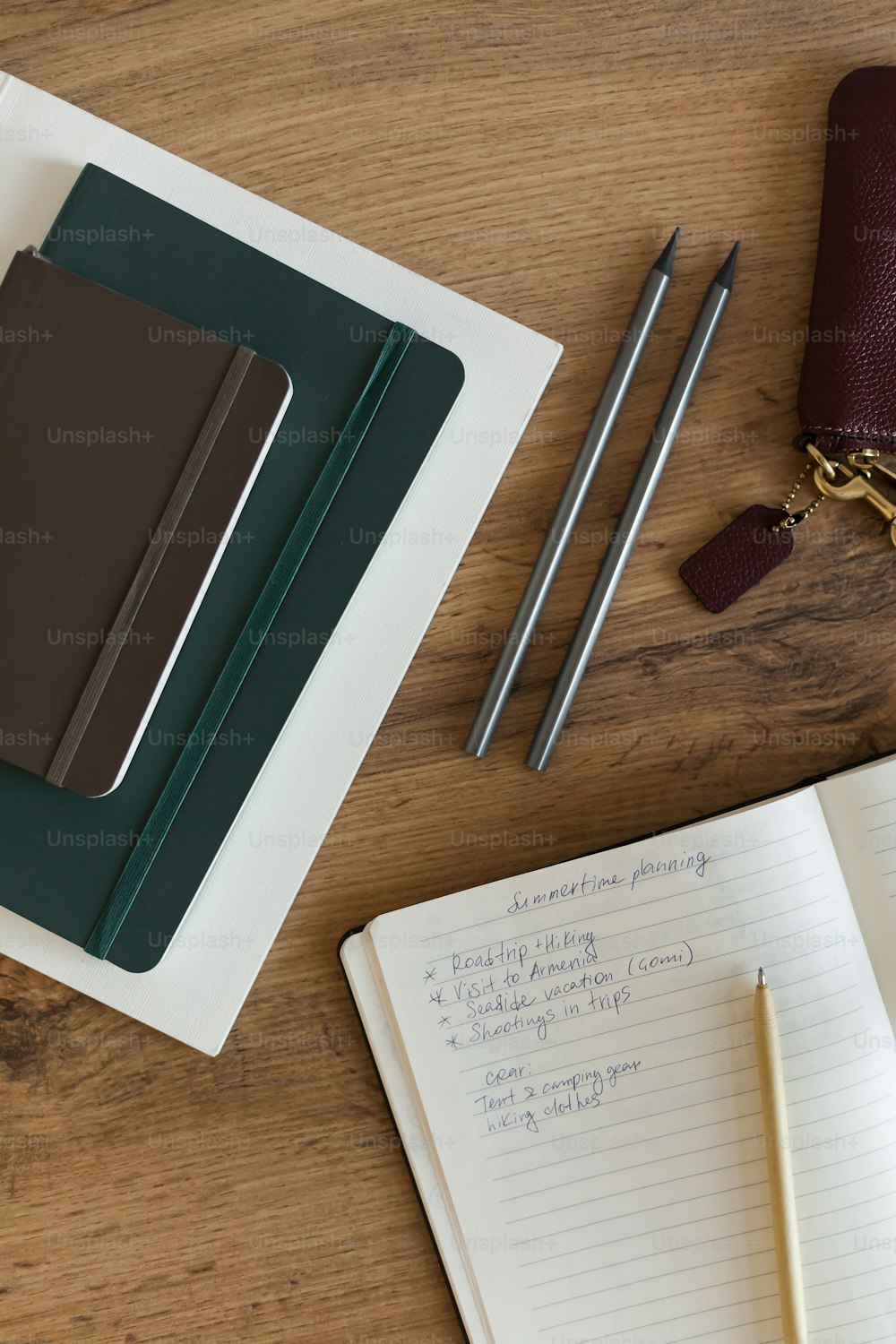 a notepad, pen, and a notebook on a table