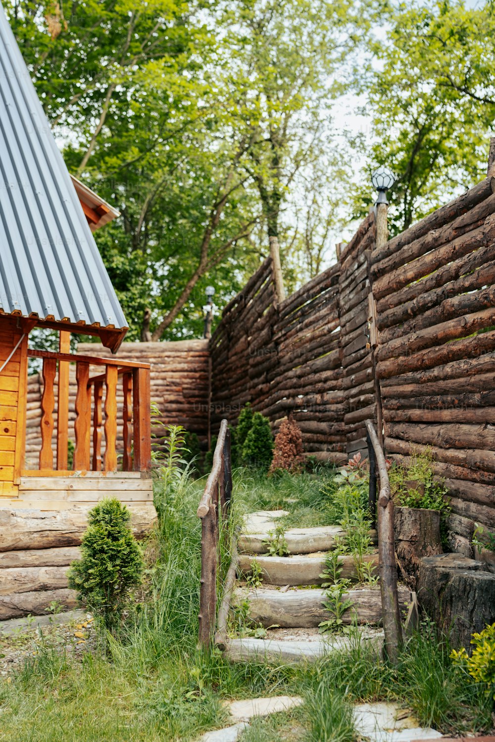 a house made of logs with a metal roof