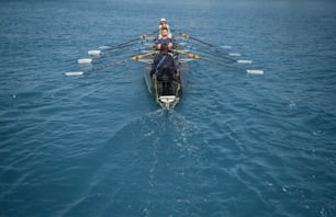 a woman rowing a boat in the middle of the ocean