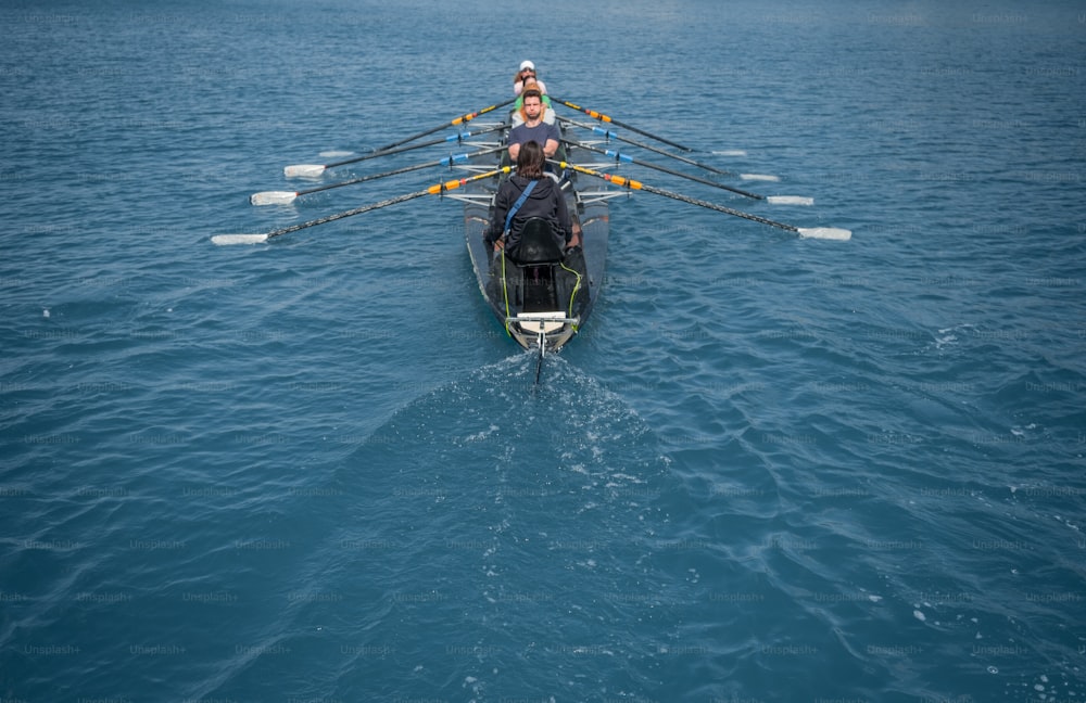 a woman rowing a boat in the middle of the ocean