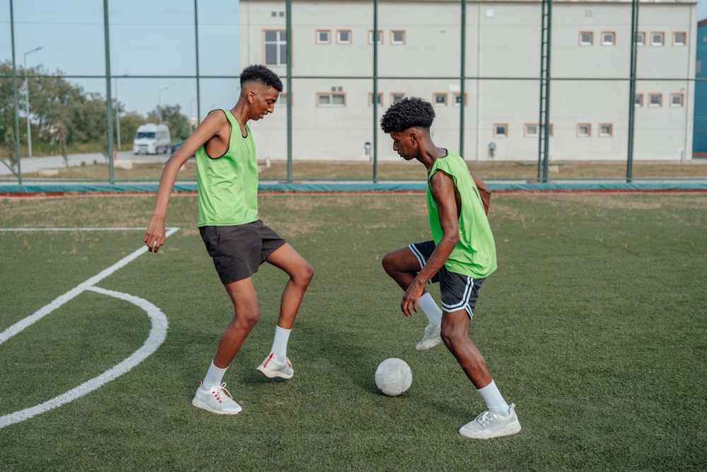 a couple of men kicking around a soccer ball