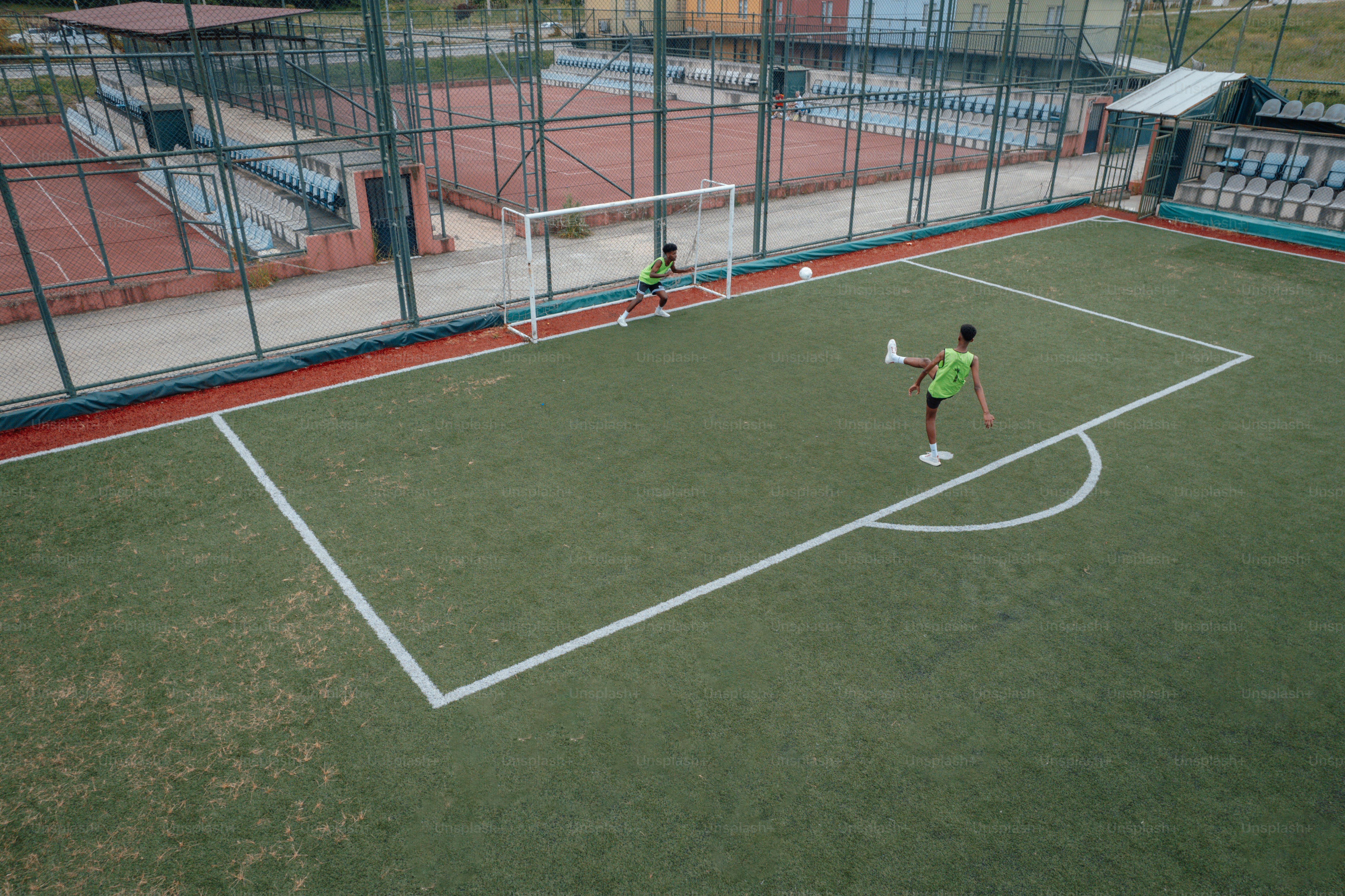 a couple of people on a field with a soccer ball