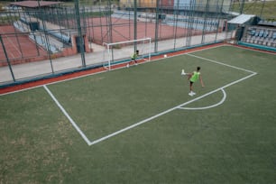 a couple of people on a field with a soccer ball