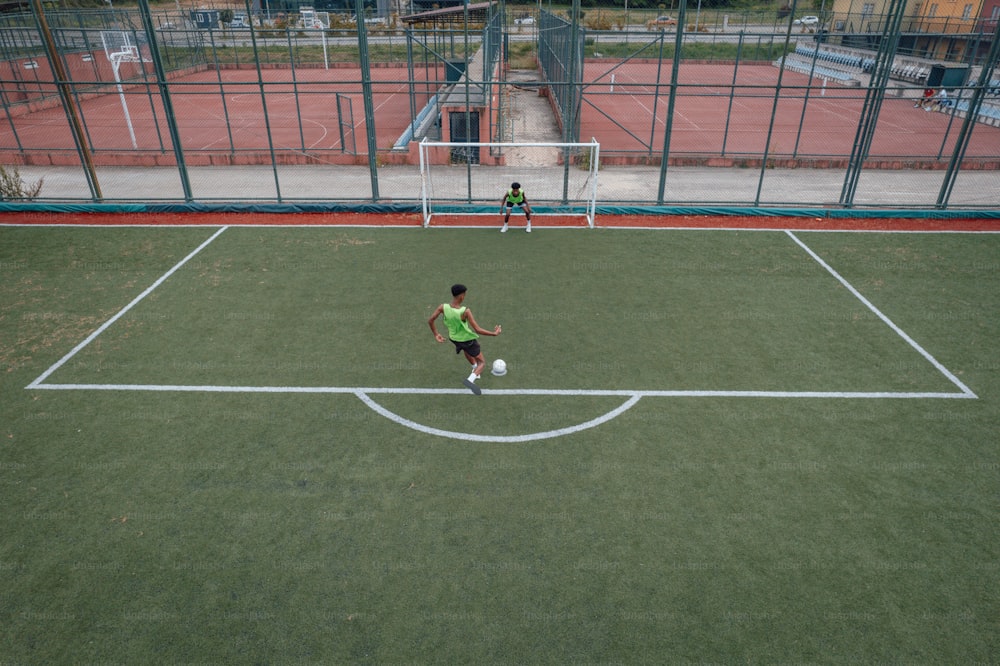 two young boys playing soccer on a soccer field