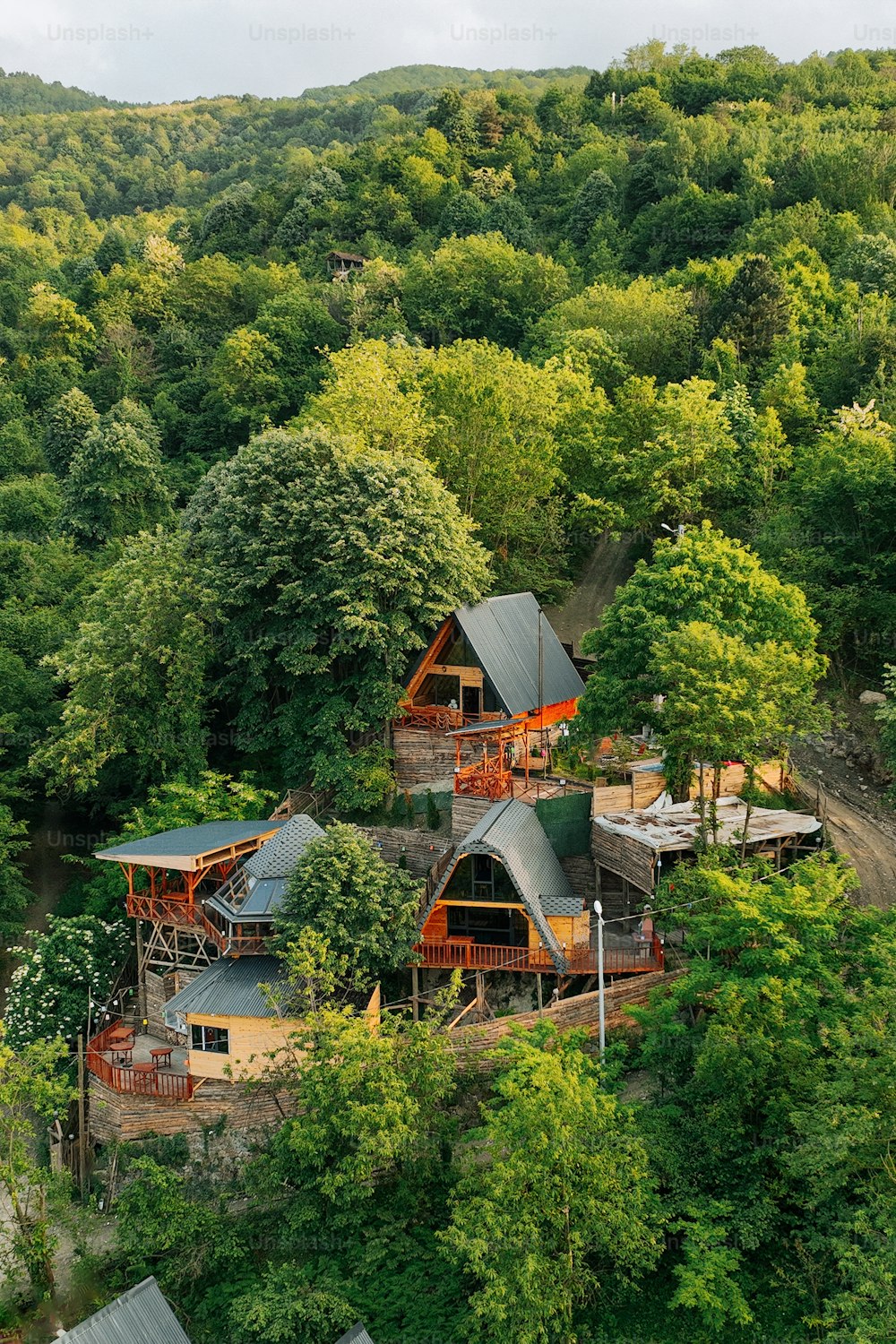 an aerial view of a house surrounded by trees