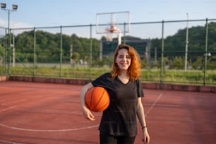 a woman holding a basketball on a basketball court