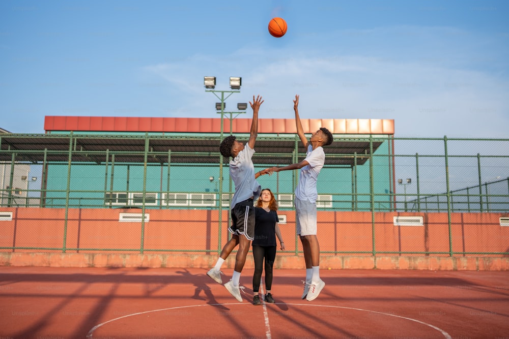 a group of young men playing a game of basketball