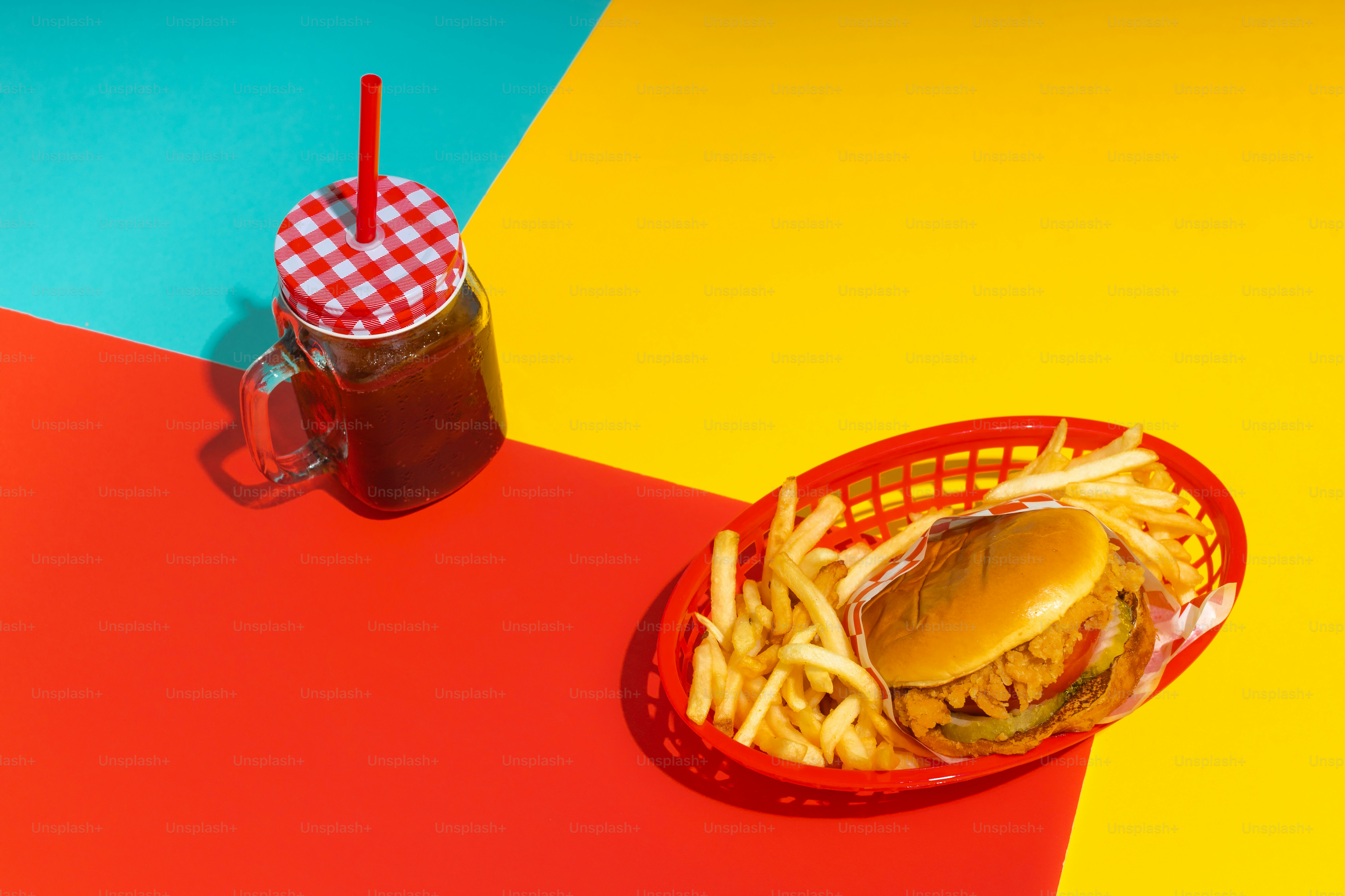 a basket of fries and a drink on a table