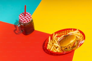 a basket of fries and a drink on a table