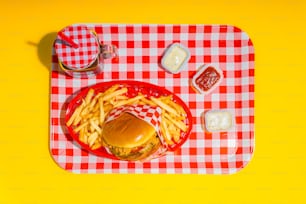 a tray with a hamburger and fries on it