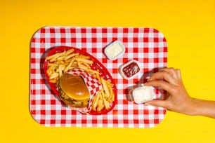 a tray with a hamburger, fries and ketchup on it
