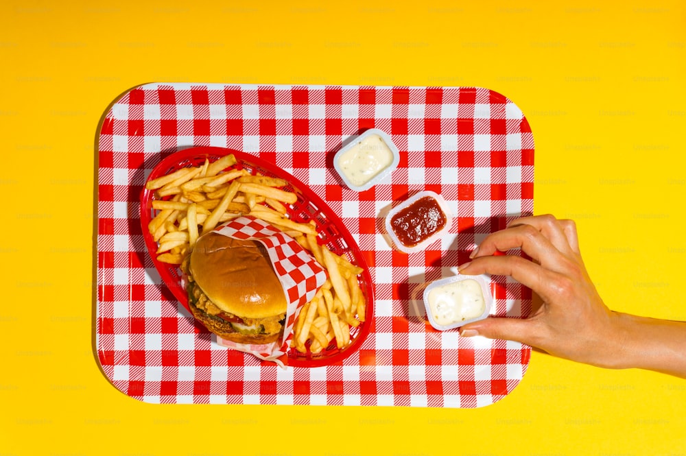 a tray with a hamburger, fries and ketchup on it