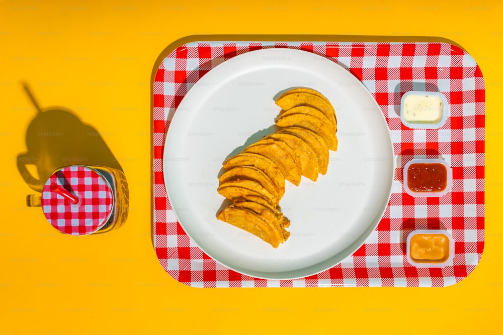 a plate of food on a red and white checkered table cloth