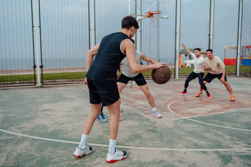 a group of young men playing a game of basketball