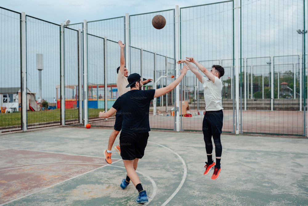 a group of young men playing a game of basketball