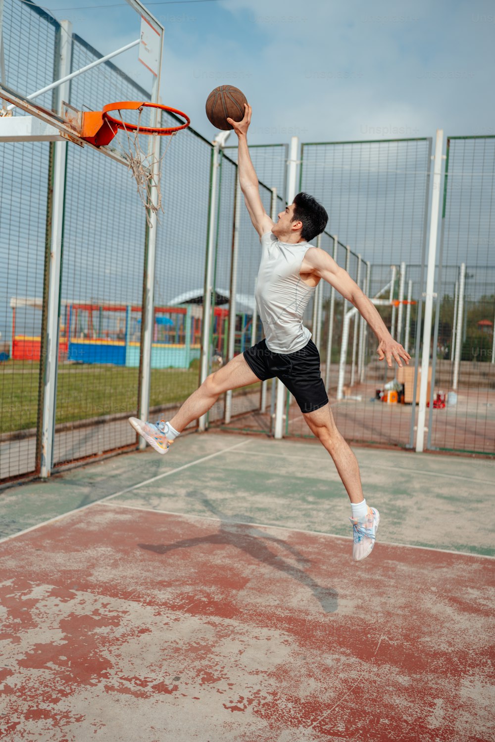 a man jumping up to dunk a basketball