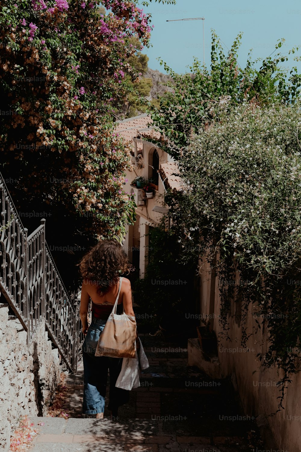 a woman walking up a set of stairs