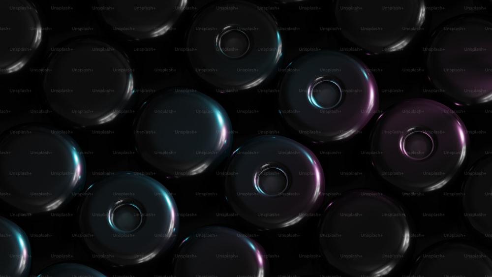 a bunch of shiny metal knobs on a black background