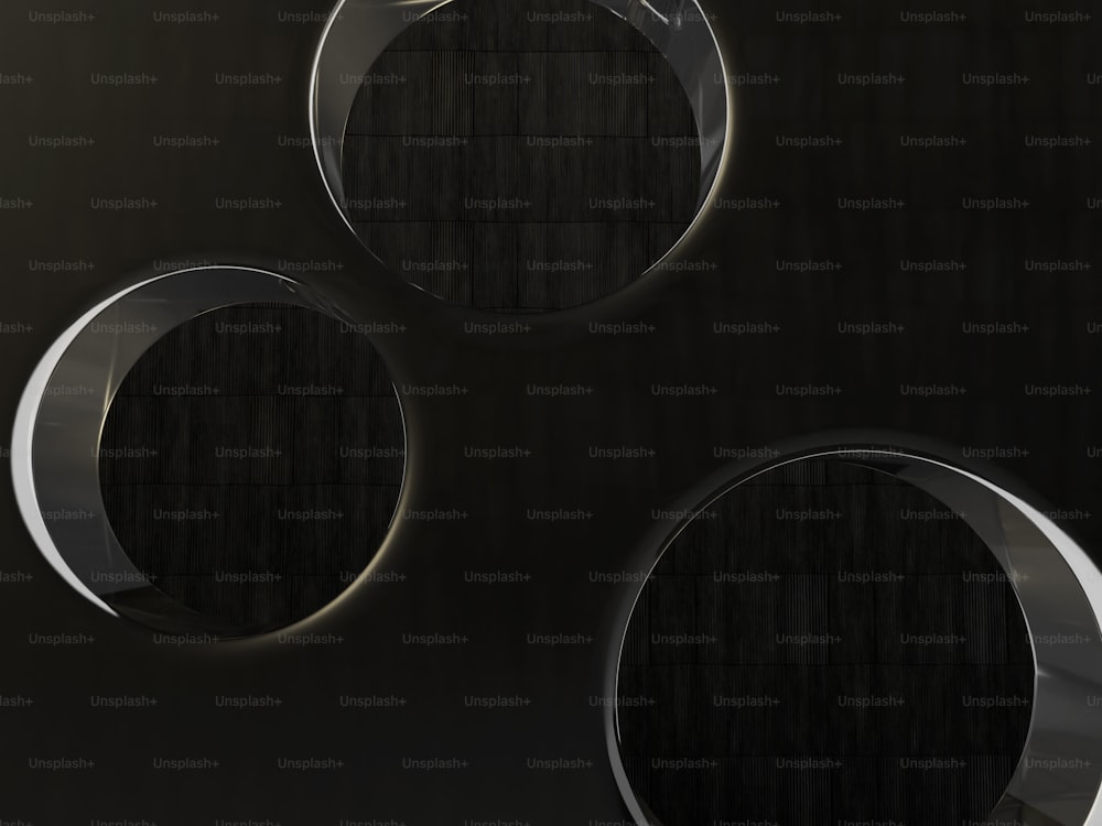 three circular mirrors on a black wall