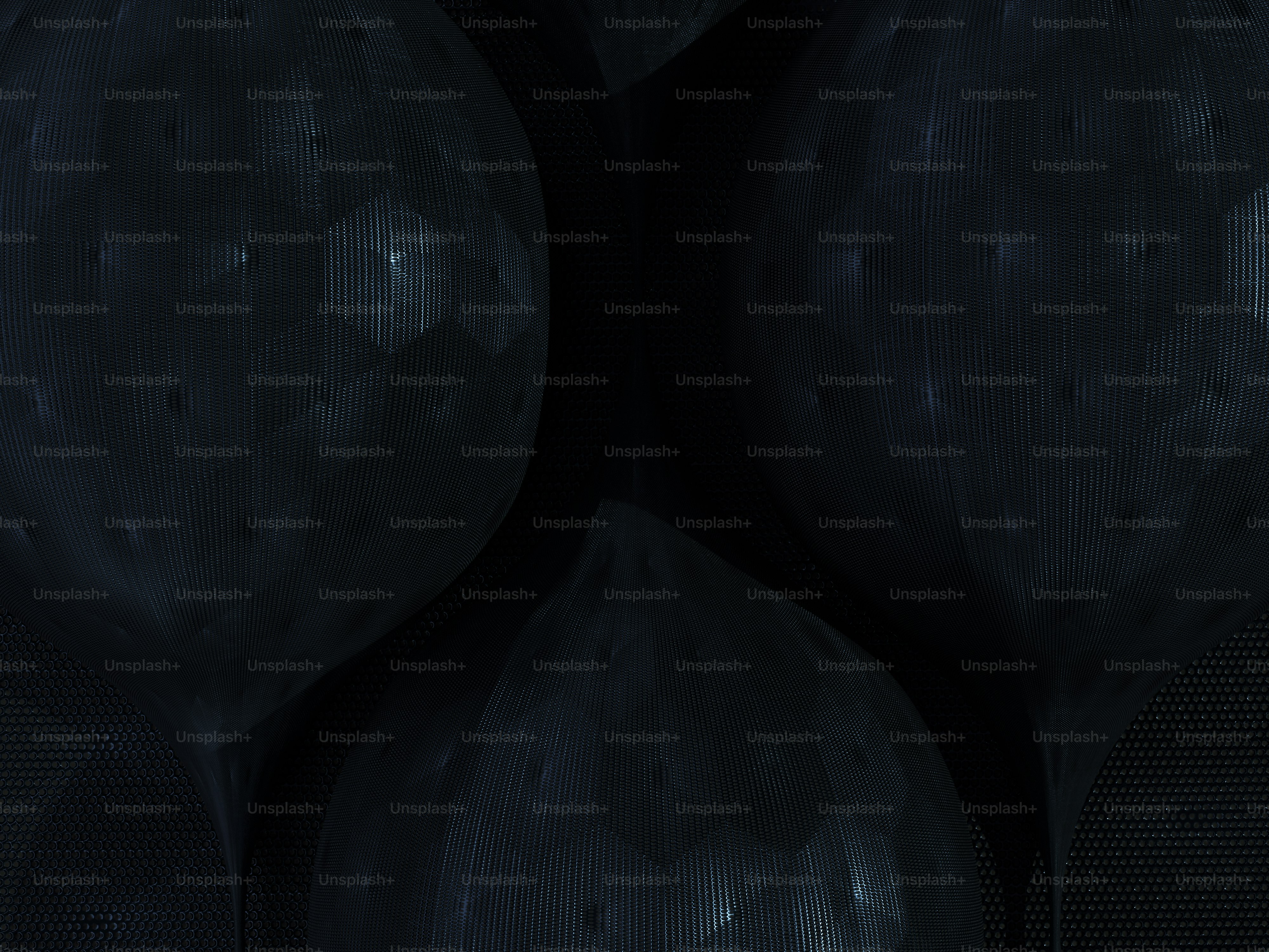 a group of black balls sitting next to each other