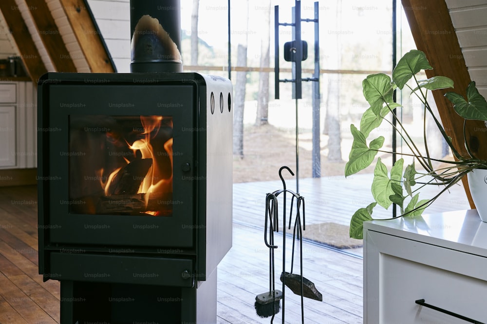 a wood burning stove in a kitchen next to a window