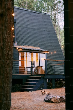 a small cabin with a deck and lights on the roof