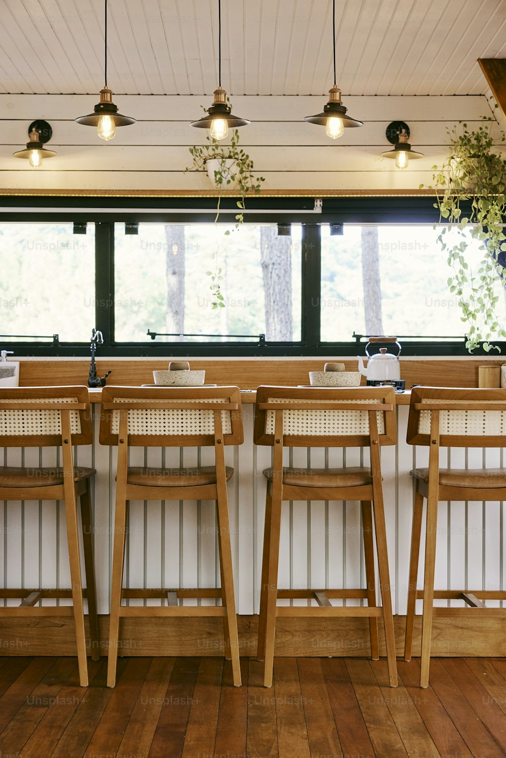 a row of chairs sitting next to each other on top of a wooden floor