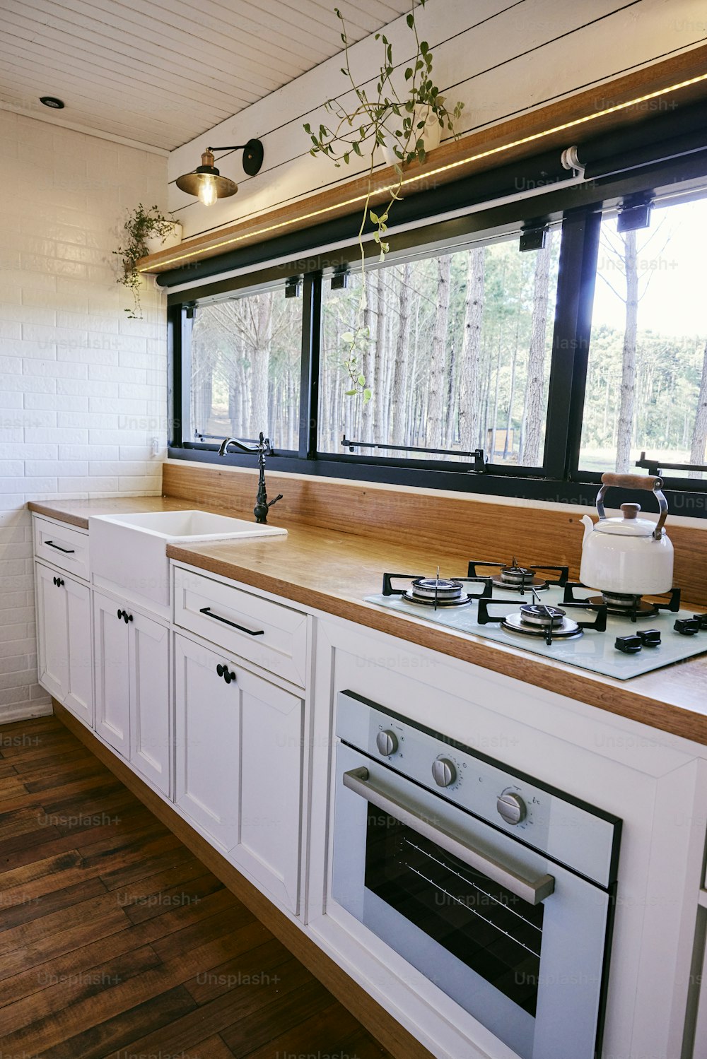 a kitchen with a stove top oven and a window