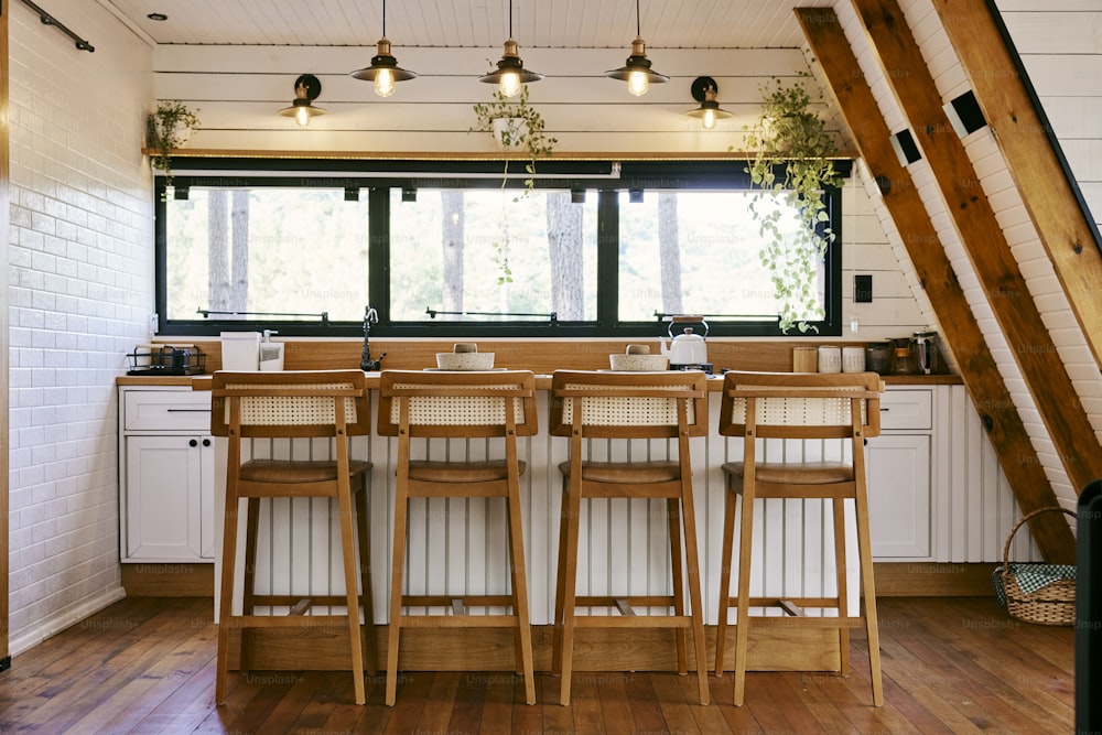 a kitchen with a lot of counter space and chairs