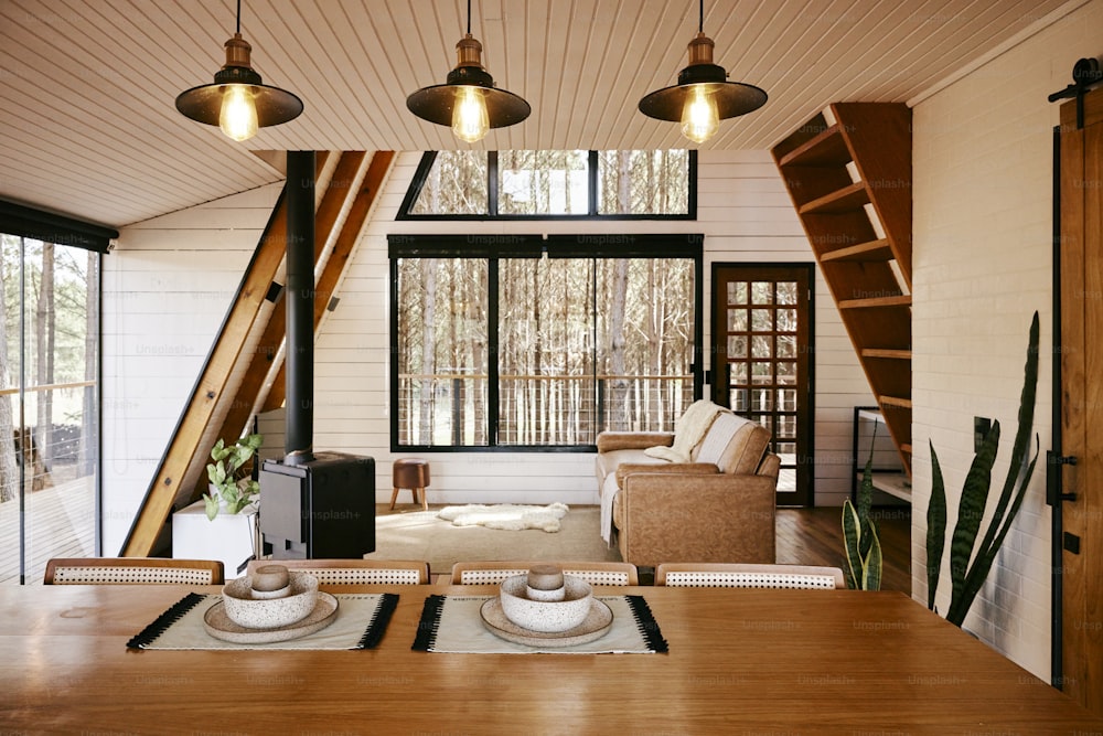 a dining room with a wooden table and chairs