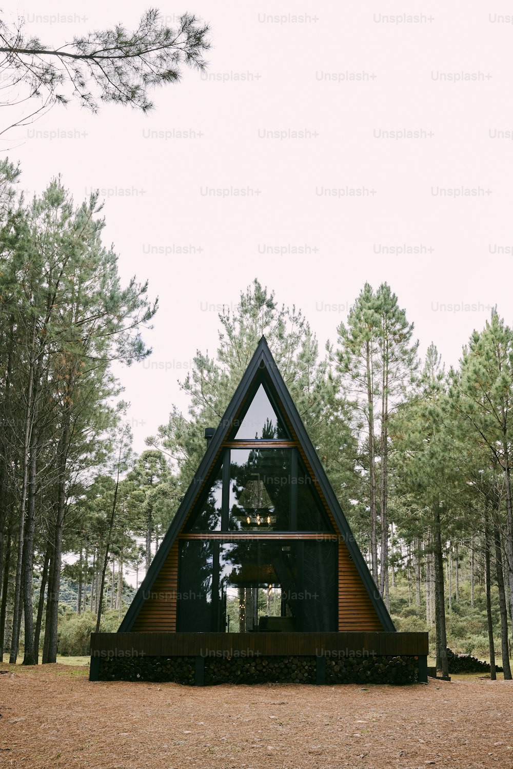 a - frame cabin in the middle of a forest