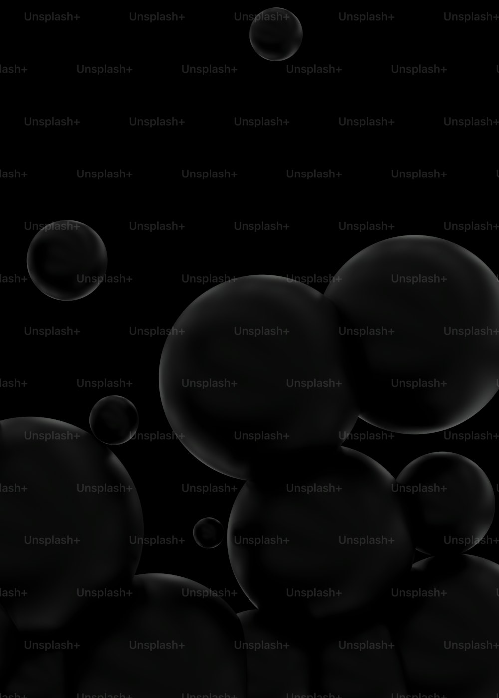 a bunch of black bubbles floating in the air