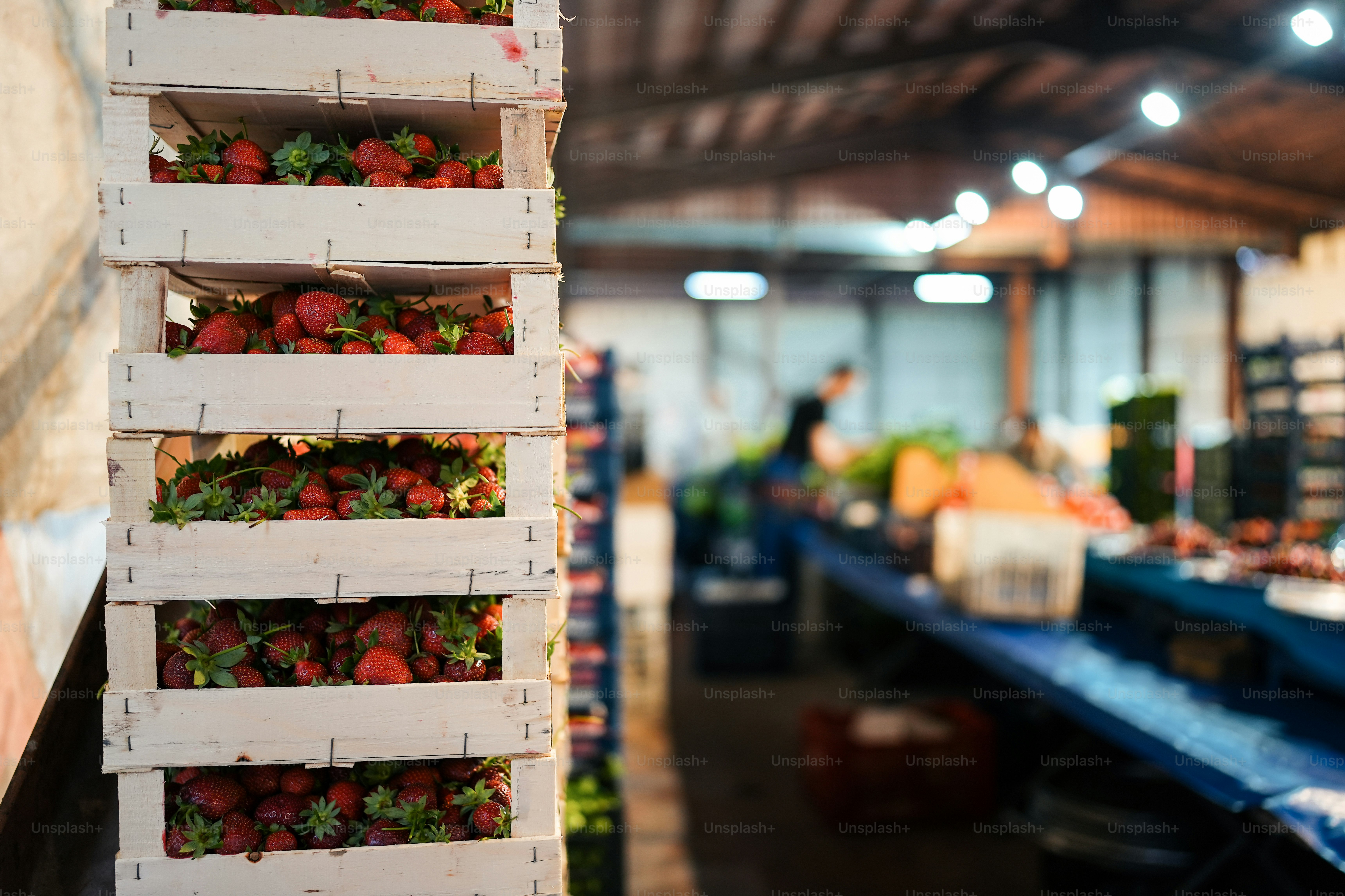 a wooden crate filled with lots of ripe strawberries