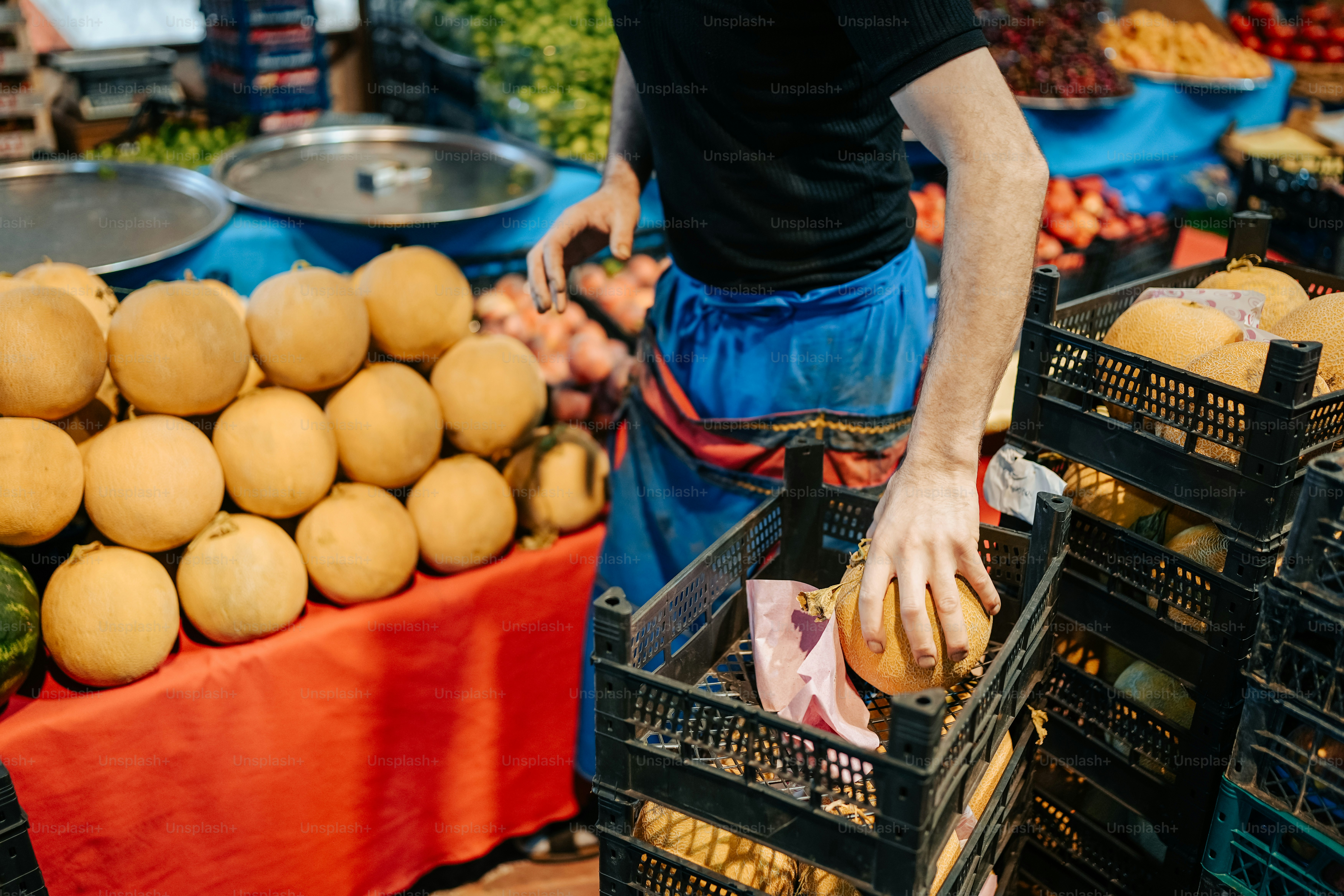 A man standing in front of a display of fruits and vegetables photo ...