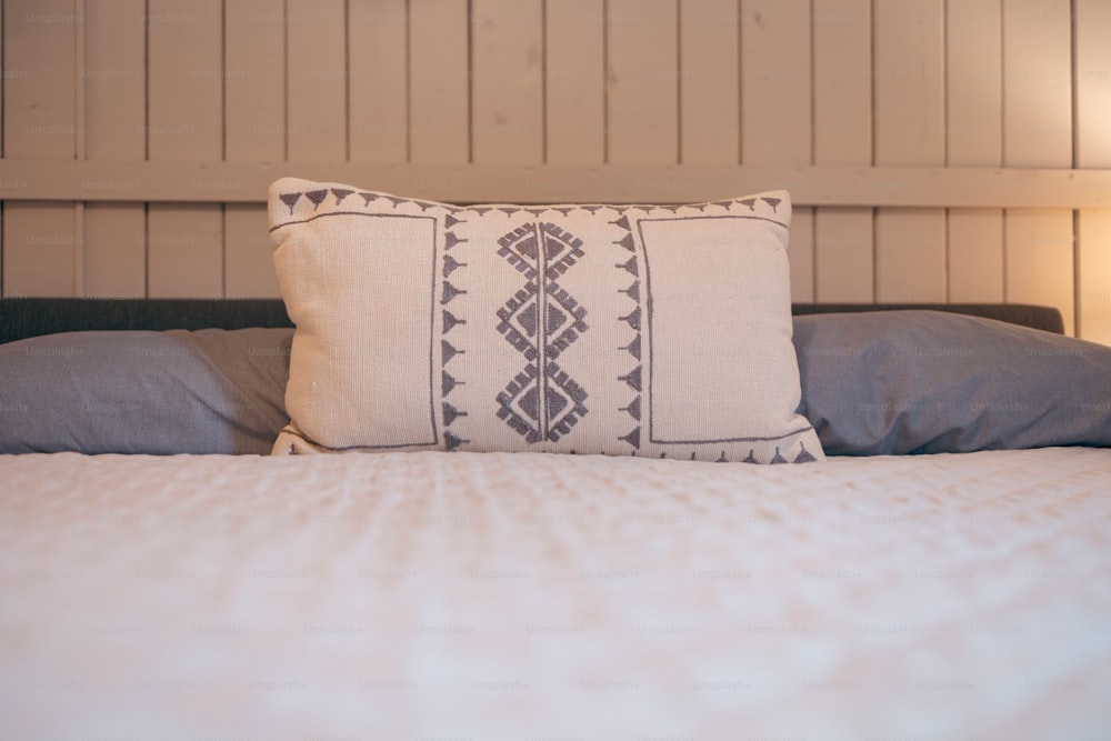 a close up of a pillow on a bed