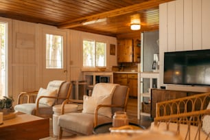 a living room filled with furniture and a flat screen tv