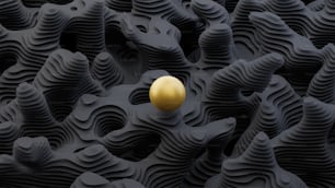 a golden egg sitting on top of a black surface