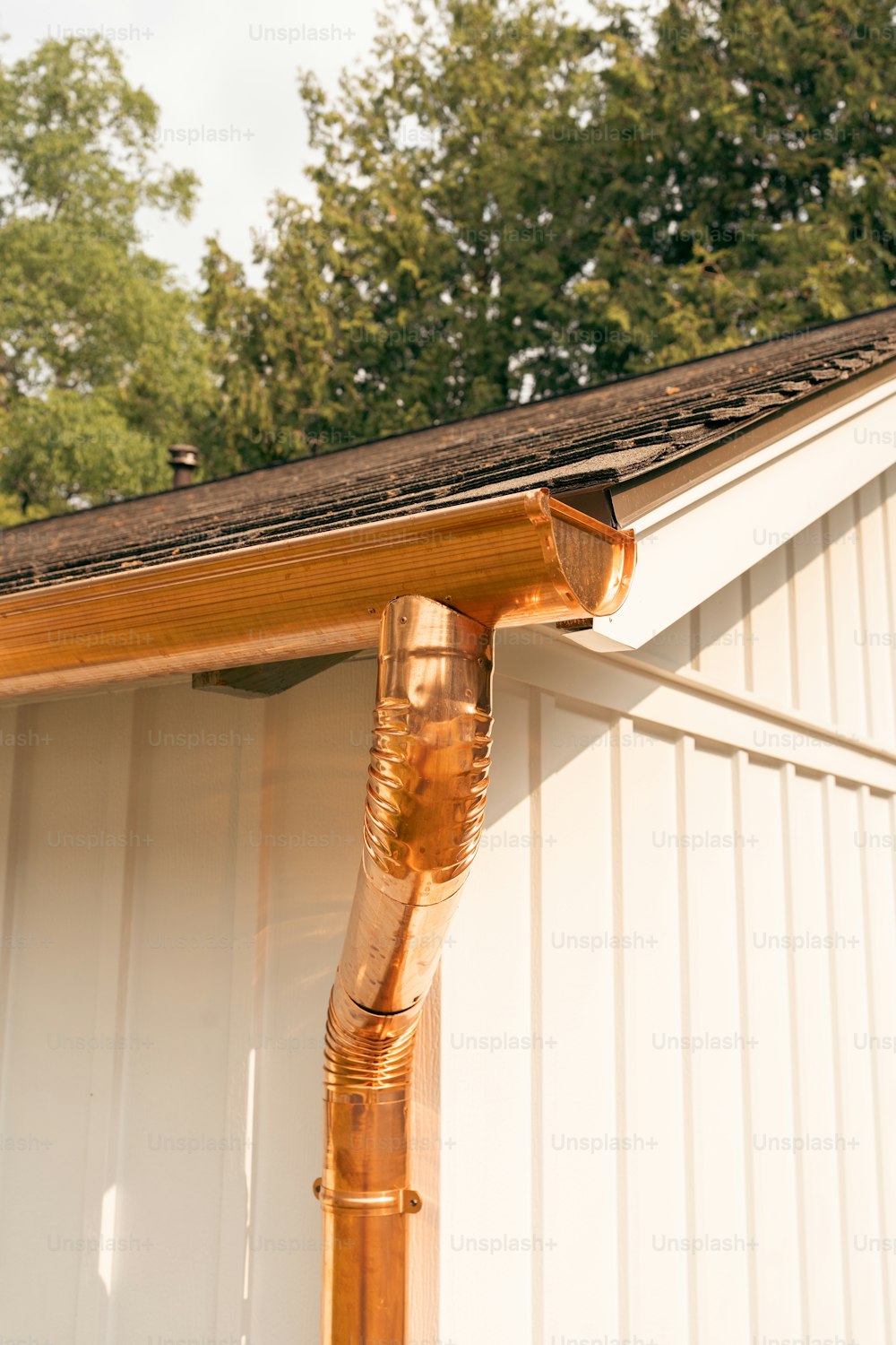 a close up of a gutter hose on the side of a house