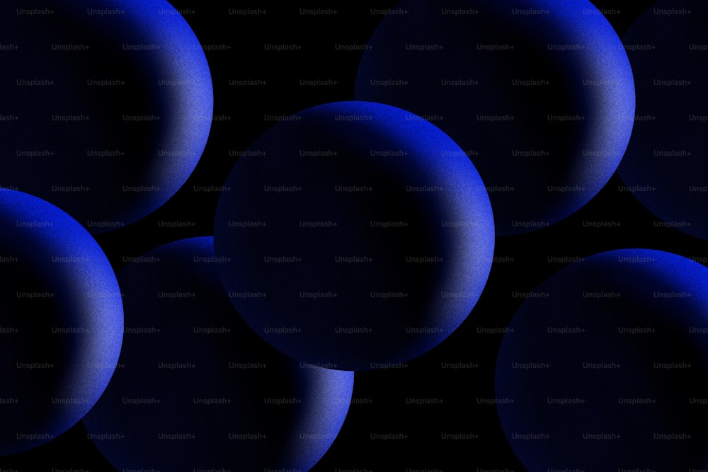 a group of blue balls on a black background