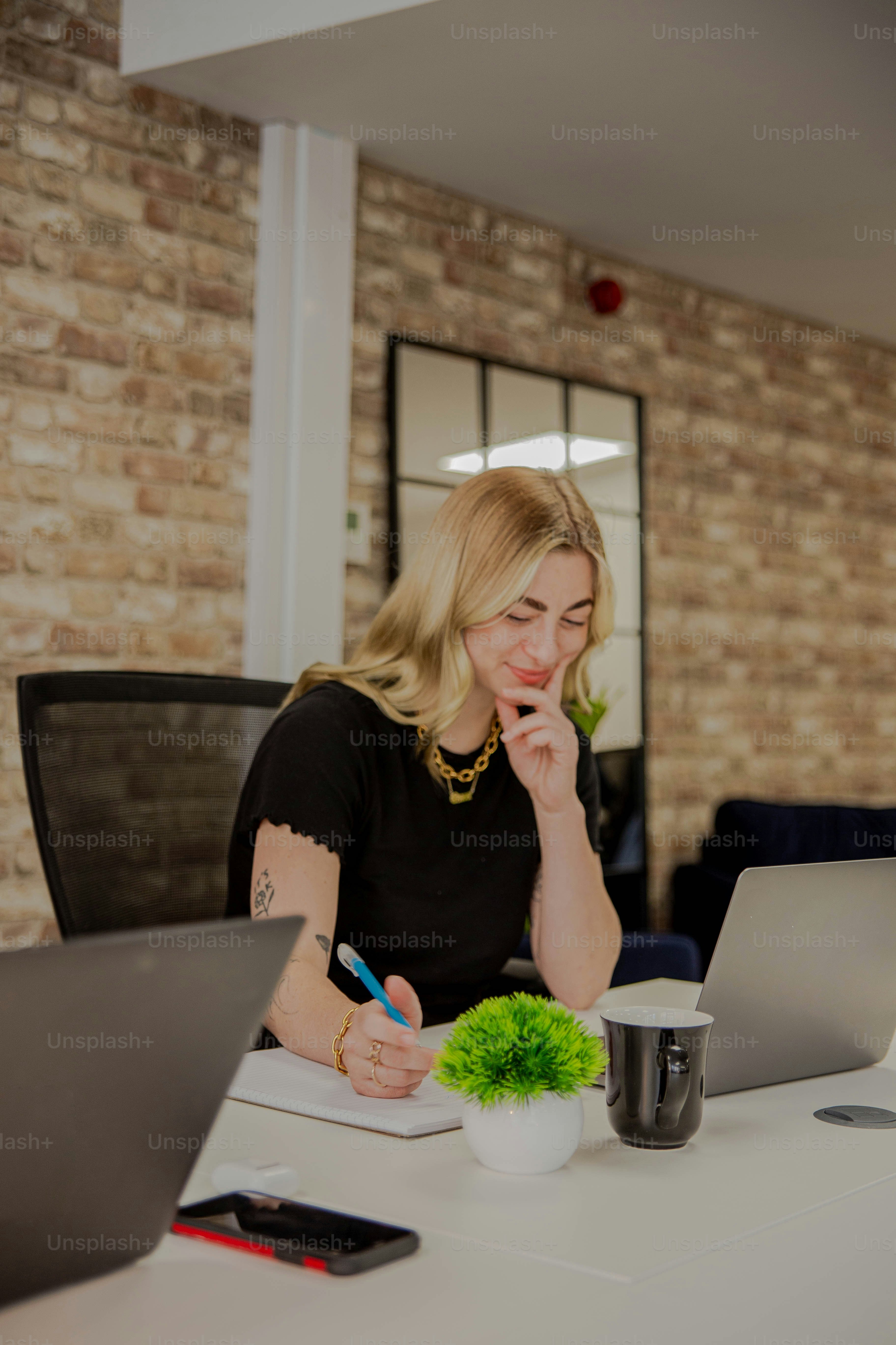 a woman sitting at a table with a laptop