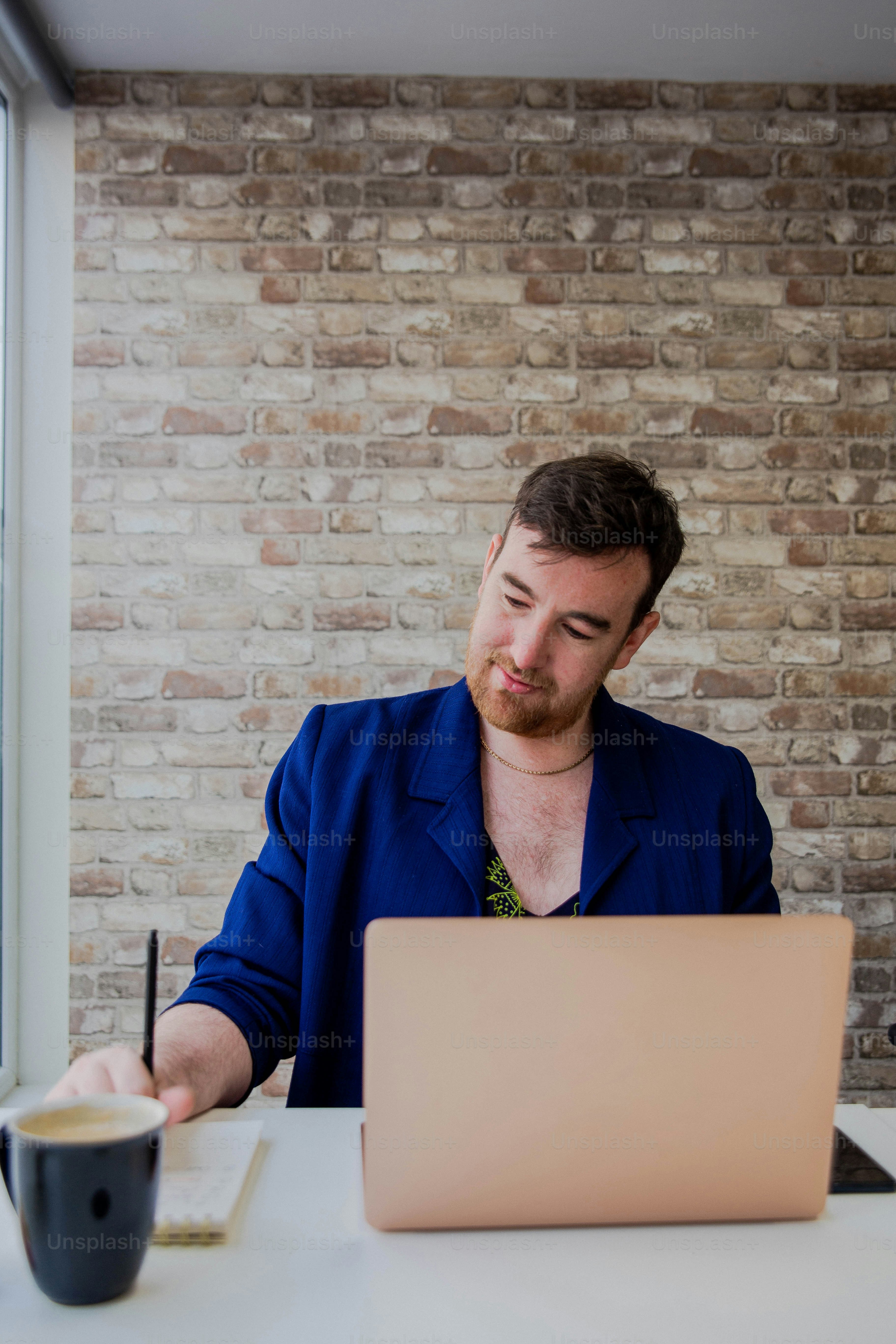 A woman sitting in front of a laptop computer photo – Office Image on ...