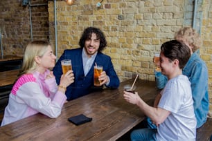 a group of people sitting around a wooden table