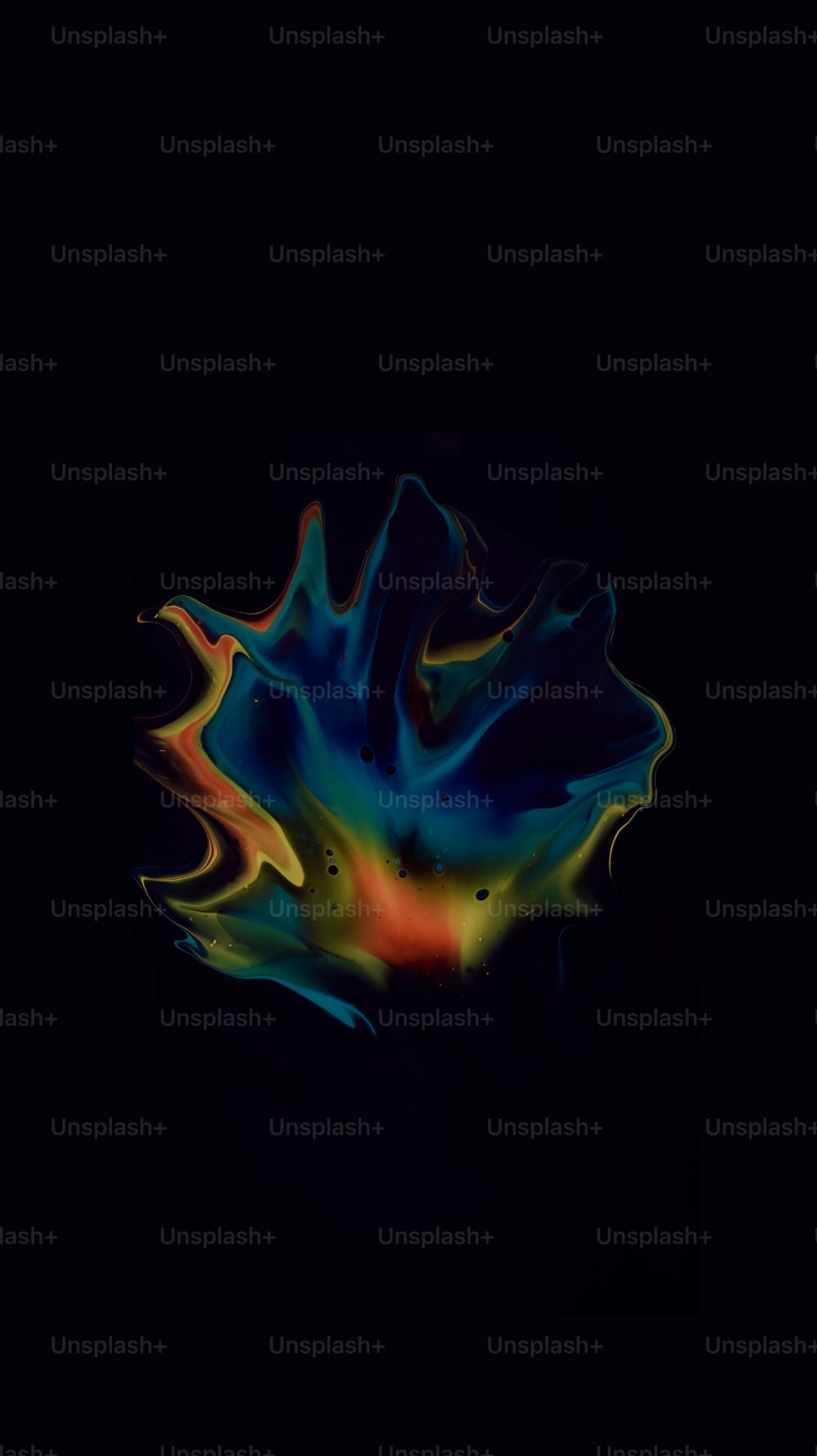 a black background with a multicolored substance