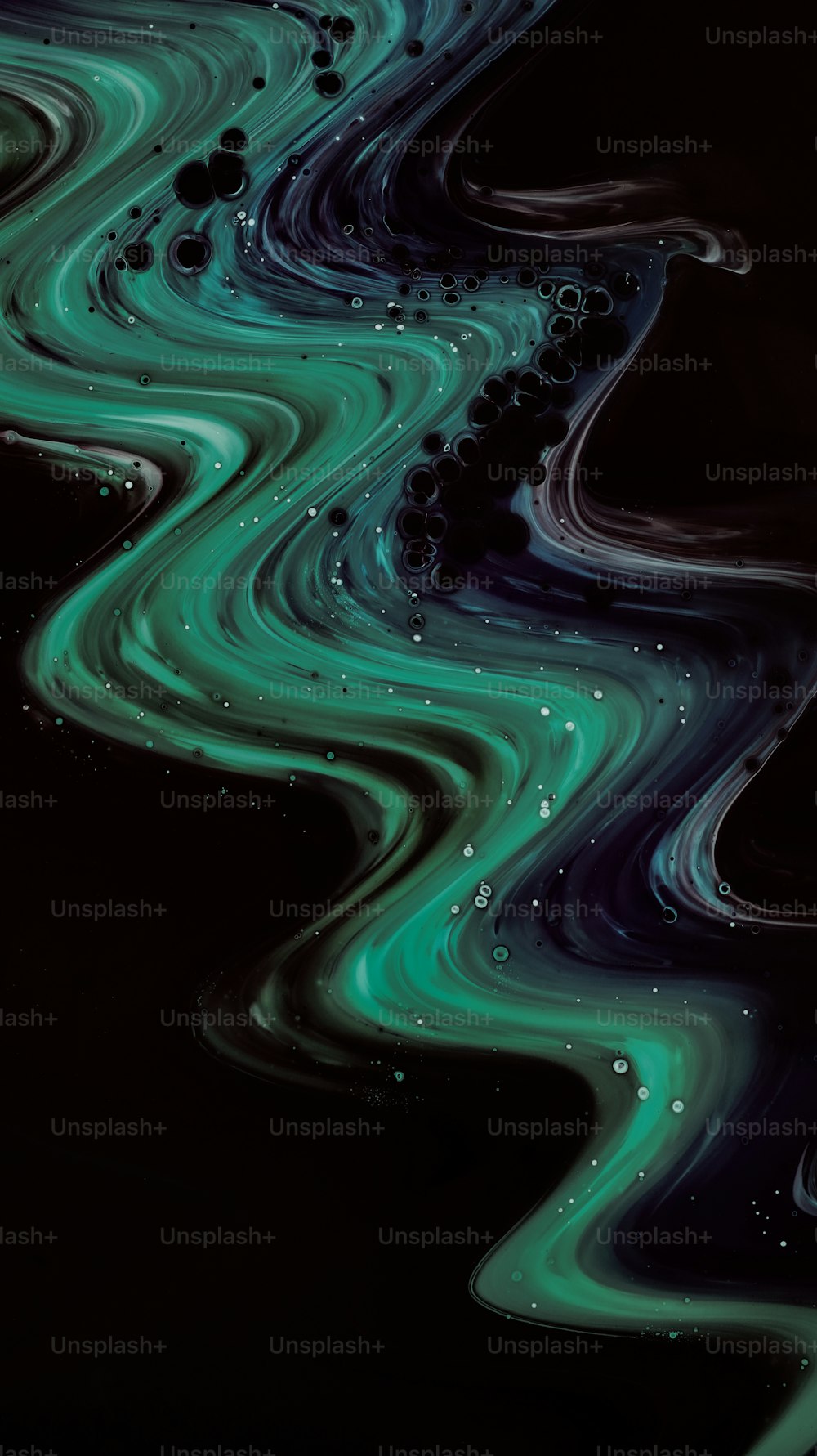 a black background with green and blue swirls