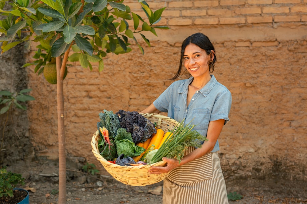 a woman holding a basket full of vegetables