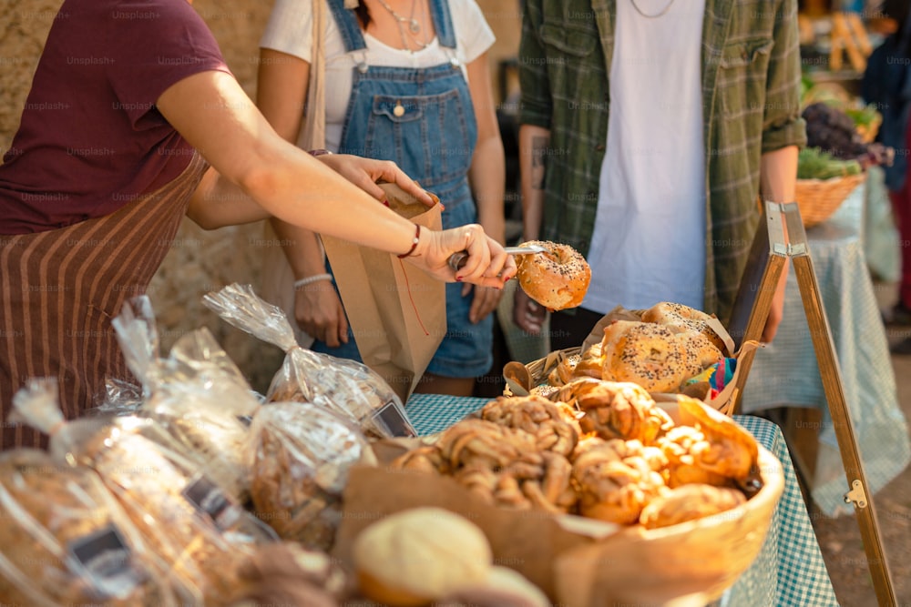 a group of people standing around a table filled with food