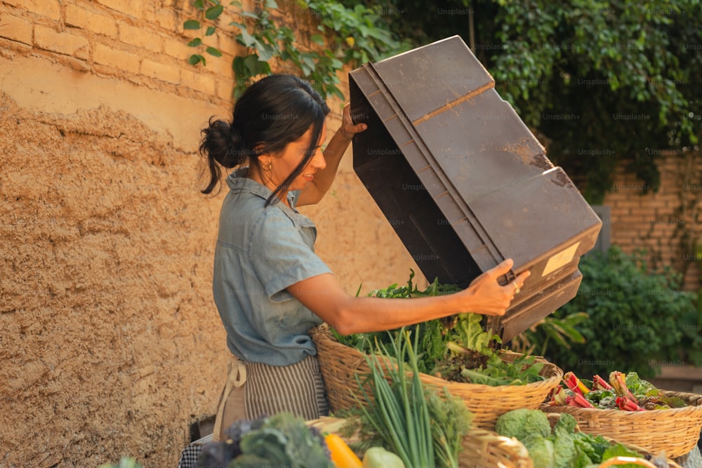 a woman is carrying a suitcase over a table of vegetables