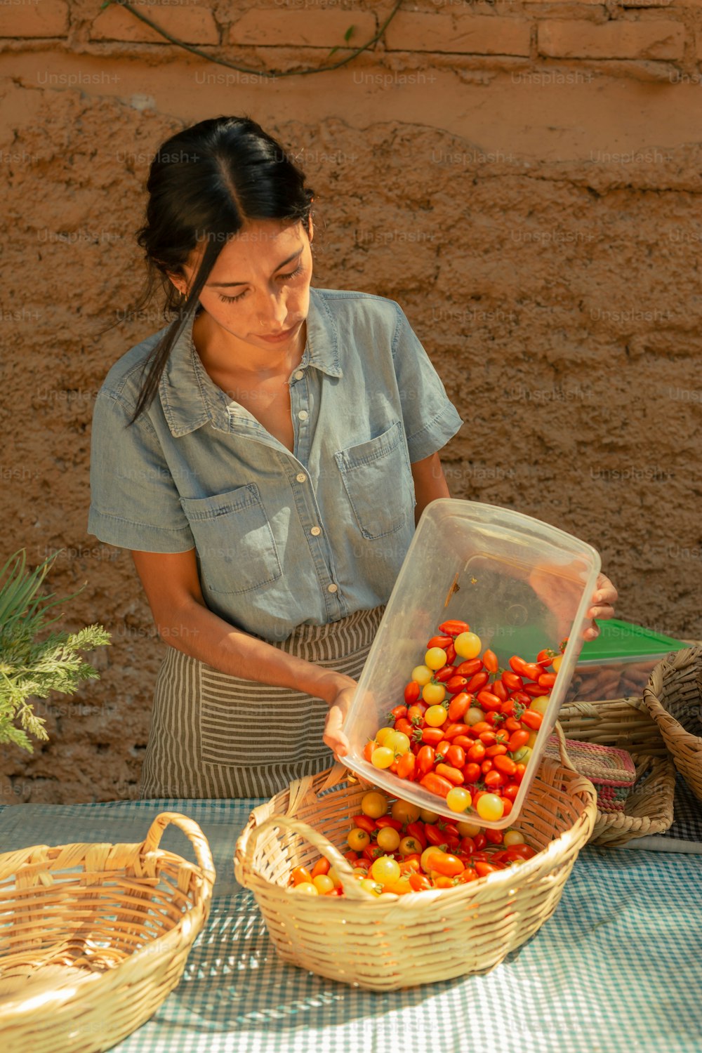 a woman standing in front of a basket filled with fruit
