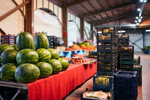 a table filled with lots of watermelons and other fruits